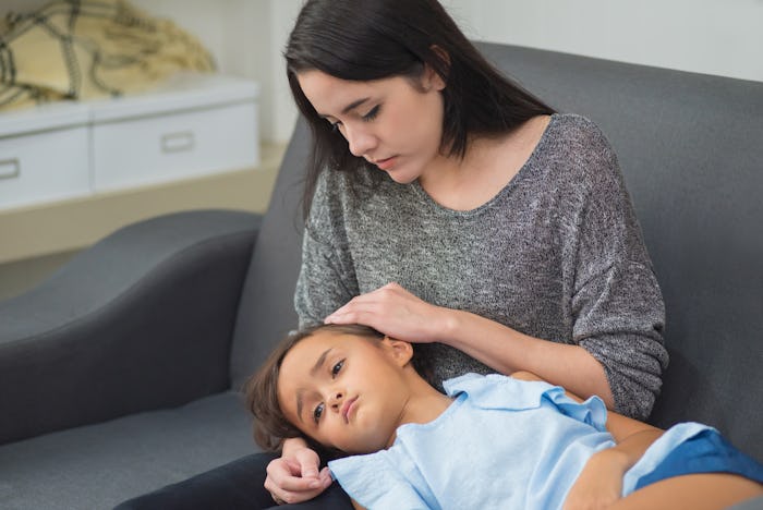 A mother carressing her child who has a stomach bug