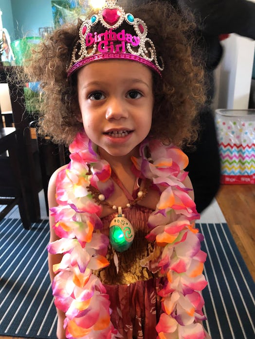 A little girl named Sophia with a birthday girl crown on her head and Hawaiian flower necklace 