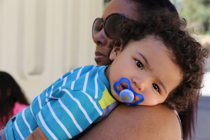 A mom holding her son on her shoulder on Mother's day