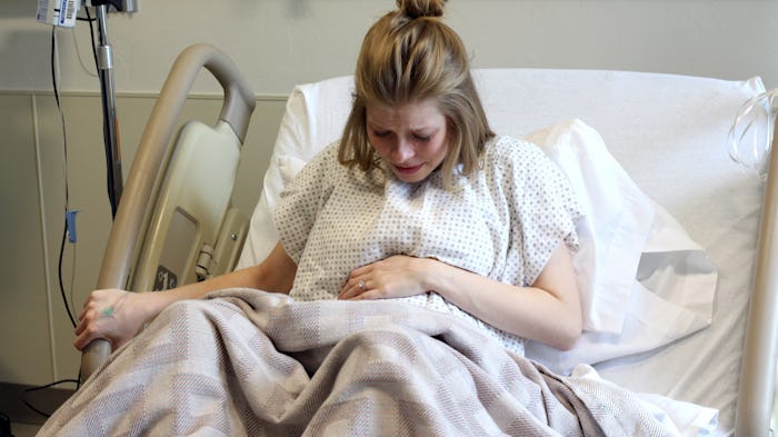 A woman in a hospital bed suffering from lazy uterus