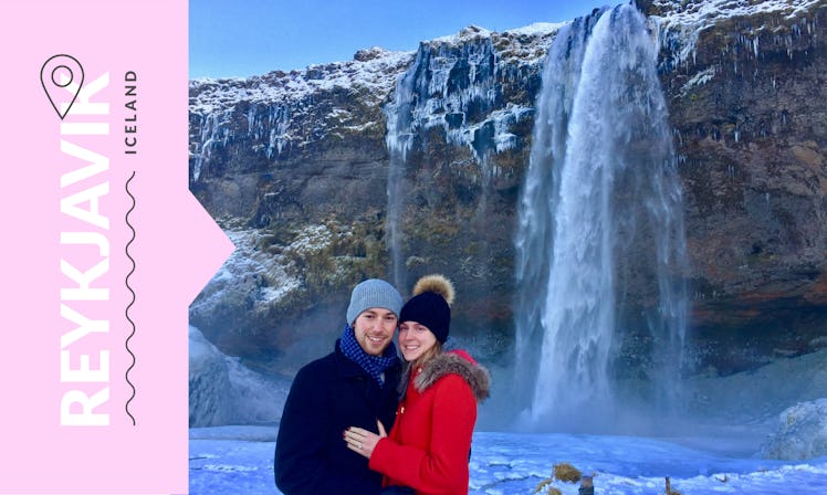 A couple posing for a photo in front of waterfall in Reykjavik