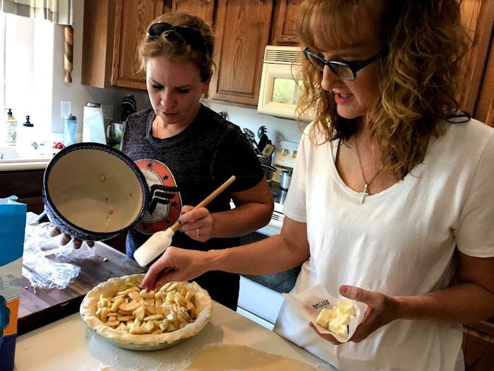 A mother and daughter in the kitchen cooking together