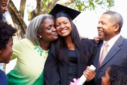 Parents hugging their college grad daughter
