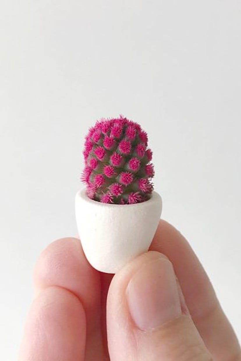 This vibrant mini cactus comes fitted in a perfectly proportional planter filled with white sand. It...