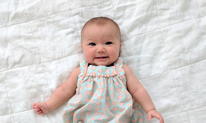 adorable baby girl lying on white blanket