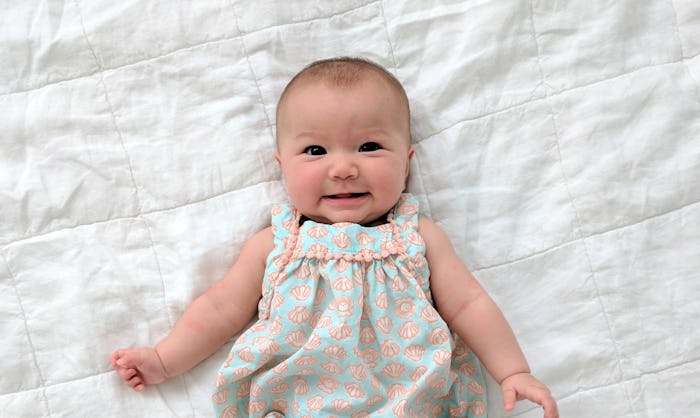 adorable baby girl lying on white blanket