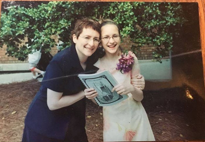 A mother and daughter posing hugged