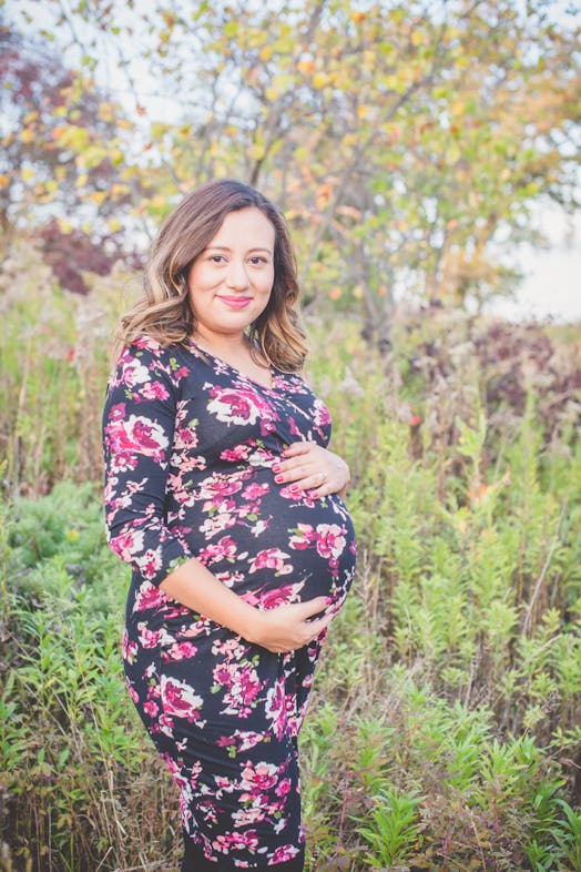 Pregnant Sarah Tenorio holding her stomach 