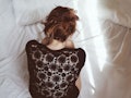 A woman struggling with PCOS curled up in bed