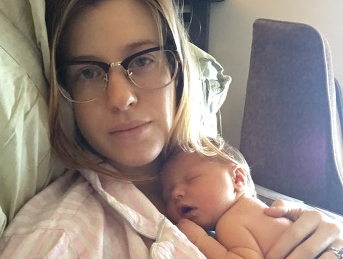 A mother holding her newborn baby on her chest.