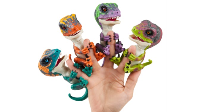 A hand with Dinosaur Fingerlings on each finger except the thumb
