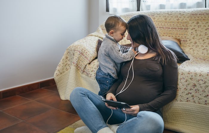 Pregnant mom playing with her first child