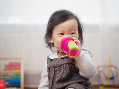 A baby girl drinking from a bottle 