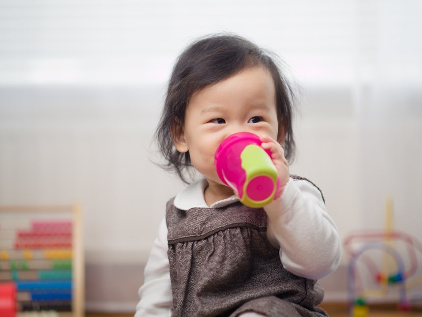 A baby girl drinking from a bottle 