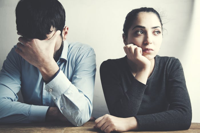 A couple sitting next to each other after having an argument regarding mom-shaming