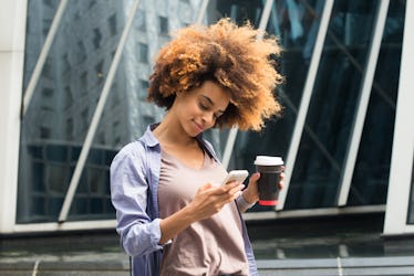 Girl drinking coffee leaving someone on read over text.