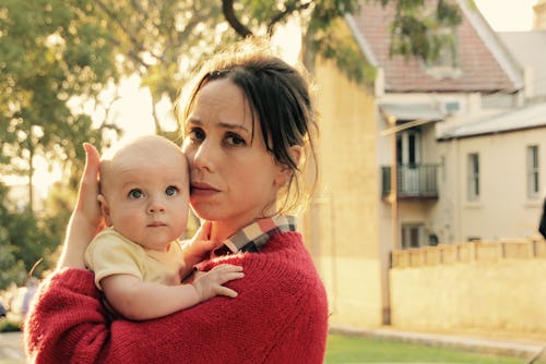 A mom holding her kid who no longer naps 