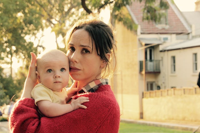 A mom holding her kid who no longer naps 