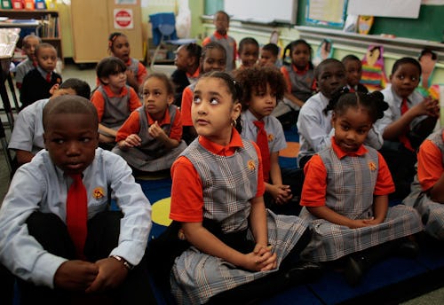 Kids wearing school uniforms while attending a class in the public school