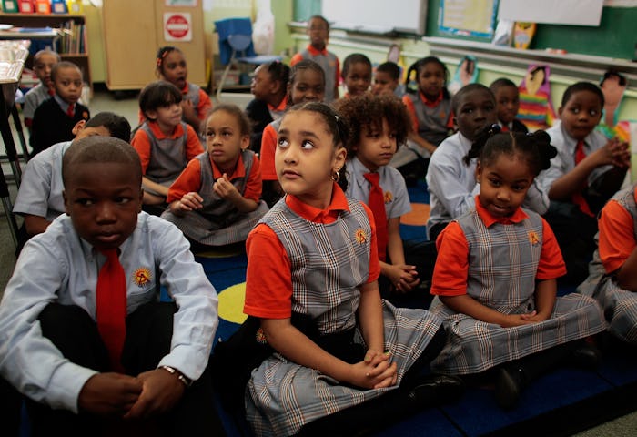 Kids wearing school uniforms while attending a class in the public school