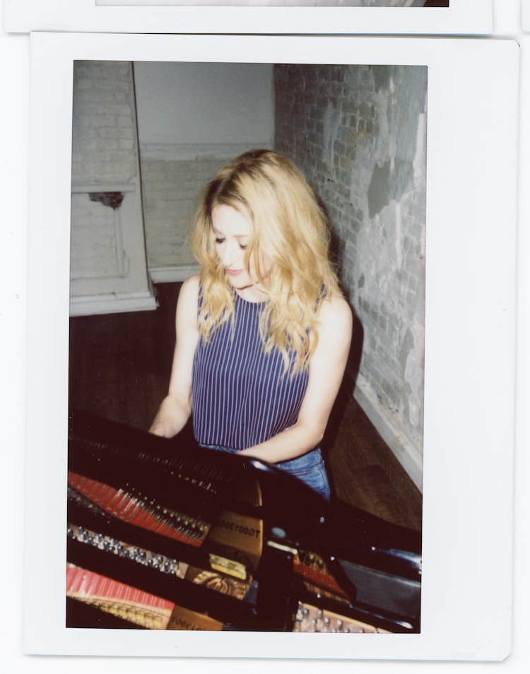 Black and white photo of Caissie Levy playing a piano    