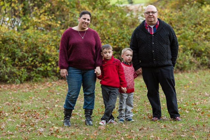 Jennifer McCue with her husband and sons in a park, smiling for a photo