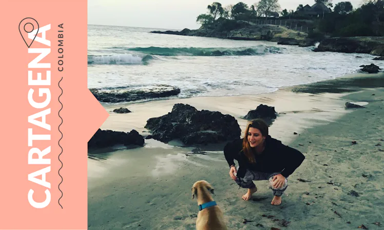 A woman and her dog at a beach in Cartagena, Columbia.