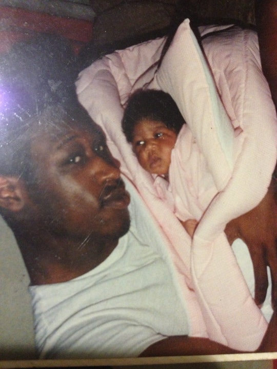 Latifah Miles being held as a newborn by her absent father