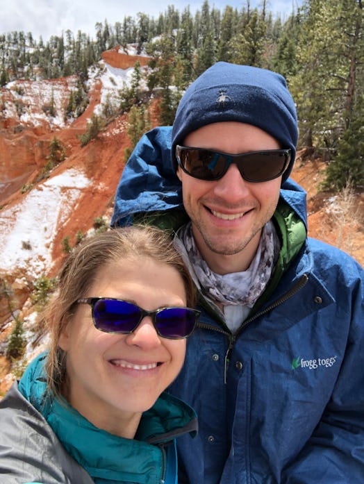 A couple is taking a selfie on a mountain hiking trip. 