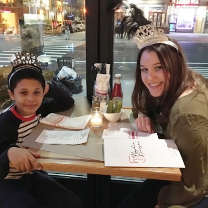Mother and child sitting at a restaurant and posing for a photo