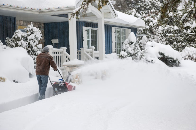 Man cleaning the snow in front of his house