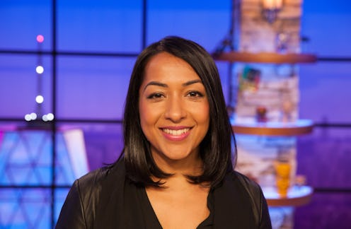 Sana Amanat in a black dress smiling at the camera from a tv studio