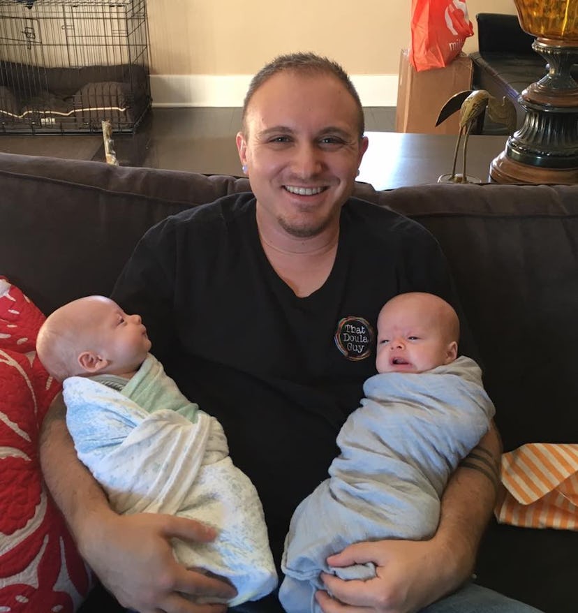 Brydum, a male doula holding two newborn babies