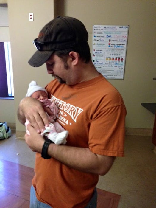 Jay Rodriquez, a male doula holding a newborn baby whose birth he assisted
