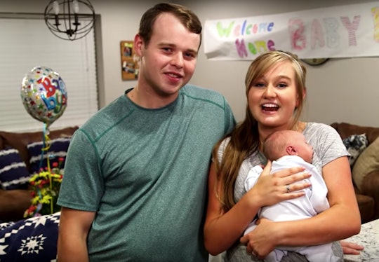 Parents Joseph & Kendra Duggar posing with their baby boy