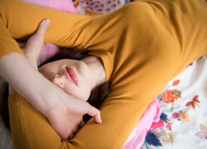 A woman with endometriosis lying on a bed