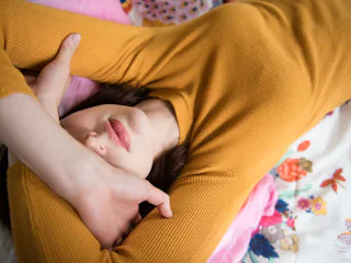 A woman with endometriosis lying on a bed