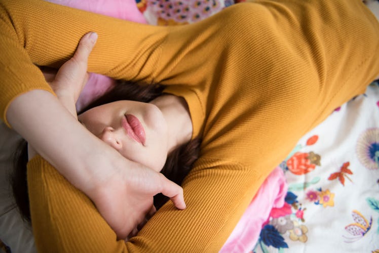 A woman with endometriosis lying on a bed