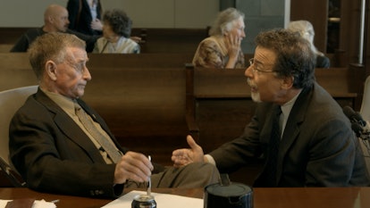 Michael Peterson and his lawyer talking in the courtroom