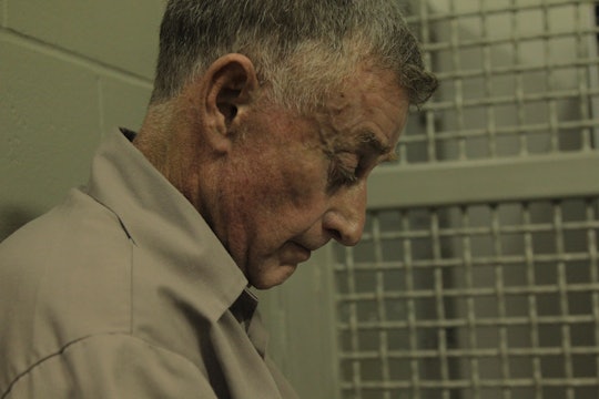 Michael Peterson with his head down in a jail cell