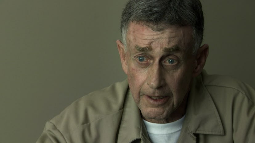 Michael Peterson looking worried at the camera in his prison uniform
