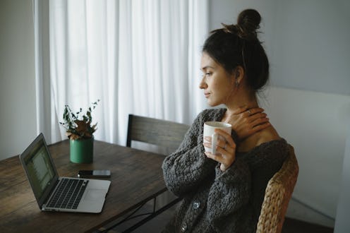 A woman sitting in front of her laptop experiencing anxiety