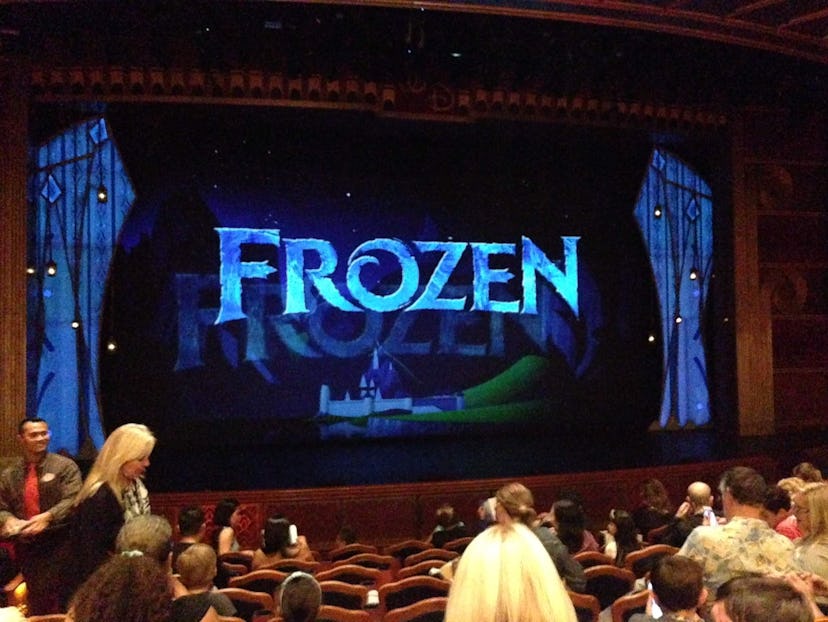 A cinema where Frozen is playing and a few people are visibly preparing for it