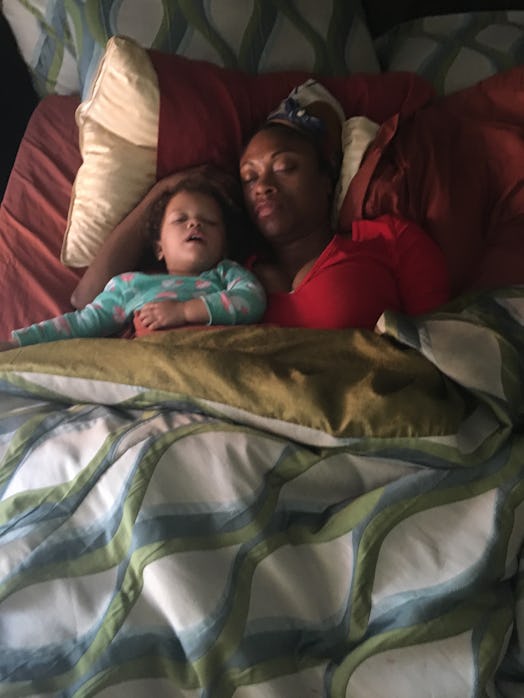 Mother and daughter sleeping together in a bed 