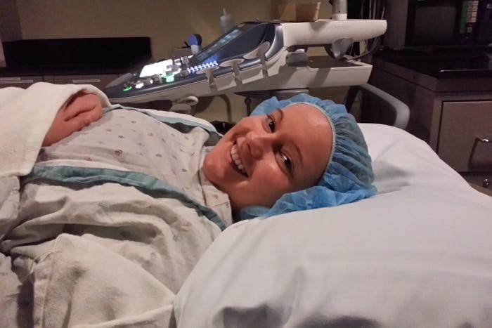 A woman lying in a hospital bed during her IVF treatment