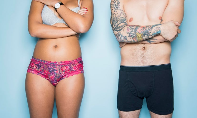 A woman and a man in underwear standing next to each other with only their torsos visible