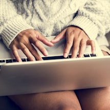 A woman searching the topic of telemedication abortion on her laptop