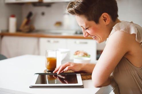 A lonely woman reading on her tablet