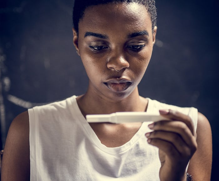 A woman with PCOS looking at her pregnancy test