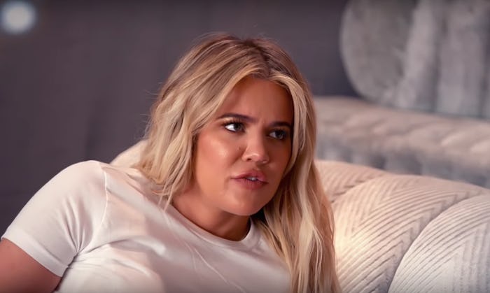 Khloe Kardashian lying on her side in a white shirt in 'Keeping Up With The Kardashians'